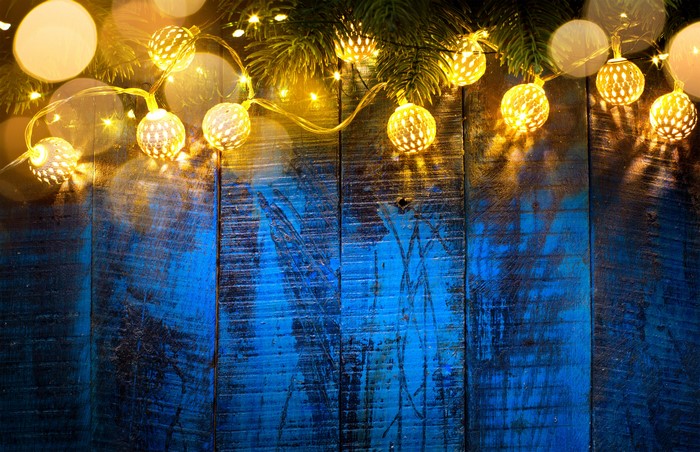 Christmas fairy lights on a wooden background