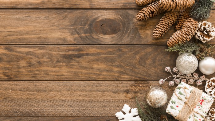 Christmas pine cones and ornaments on wood planks