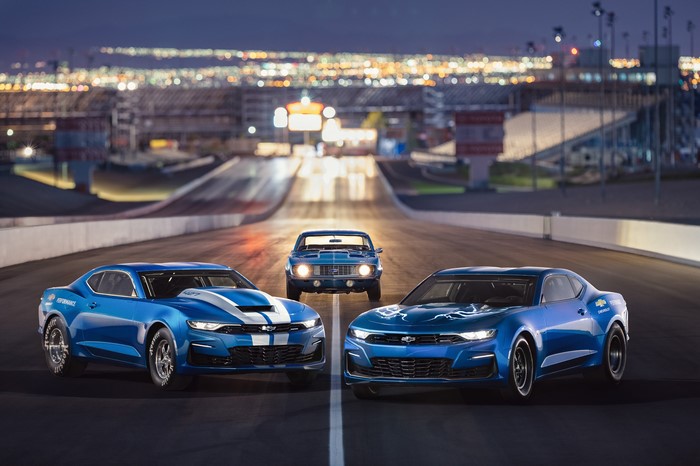 Three Chevrolet Camaros on a Drag Strip at Night