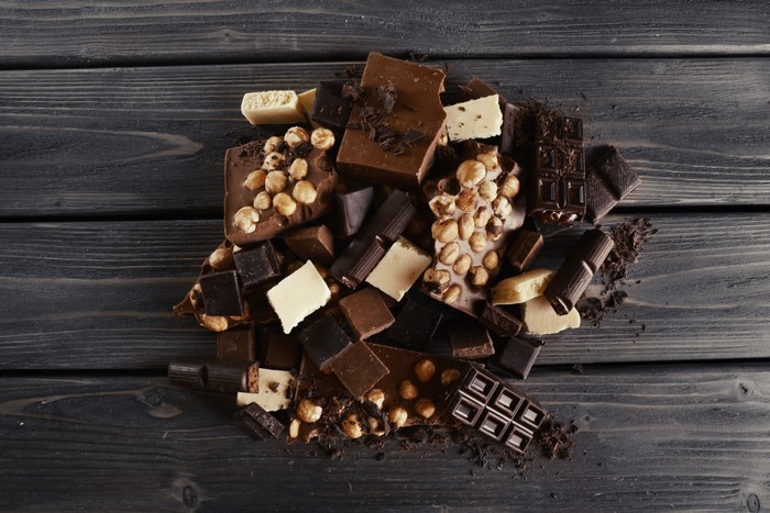 Chocolate pieces with nuts on wooden planks