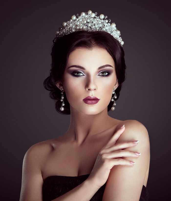 Woman with Crown and Pearl Earrings