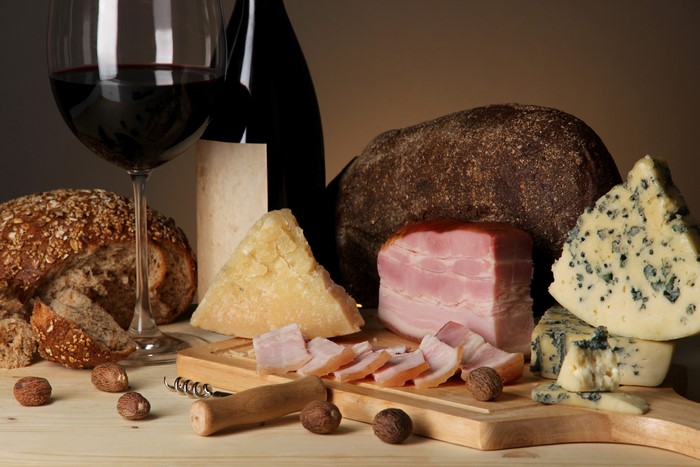 Cheese, Wine, Bread, Ham, Nuts, and Cutting Board