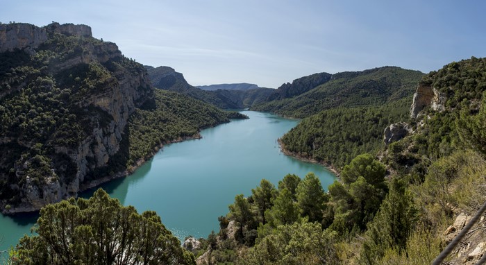 Turquoise river flowing through forested mountains in Catalonia, Spain
