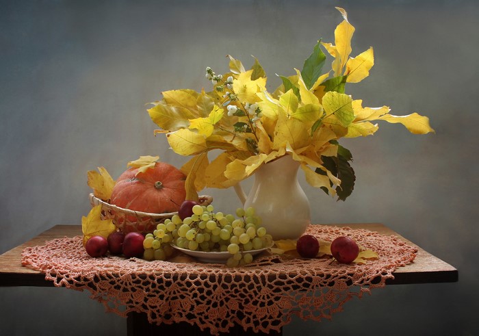 Autumn still-life with pumpkin, grapes, and foliage
