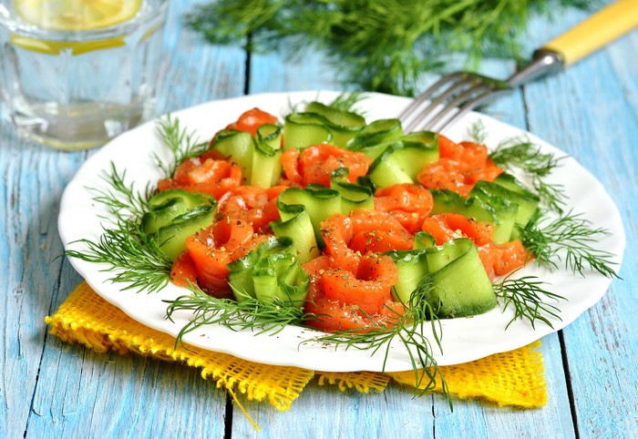 Salmon and cucumber salad with dill on a plate