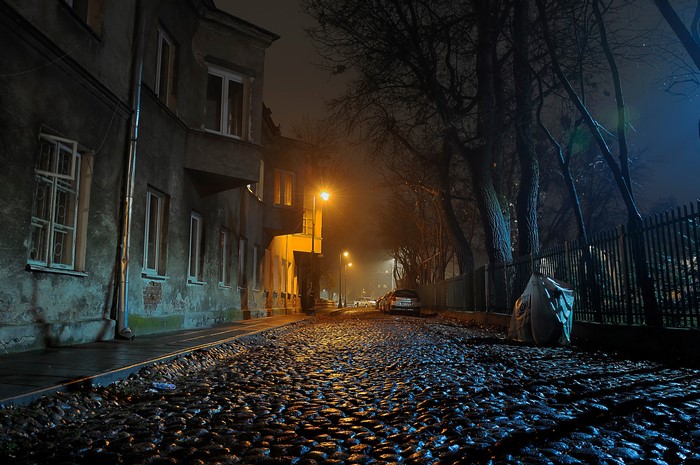 Cobblestone street at night in Warsaw, Poland