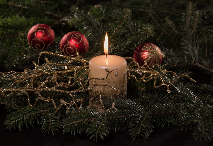Christmas candle with ornaments and fir branches