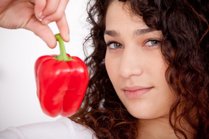 Woman holding a red bell pepper