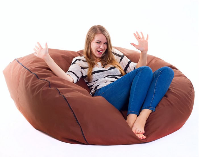 Young woman sitting on a large beanbag chair