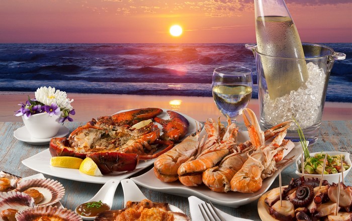 Seafood feast on the beach at sunset