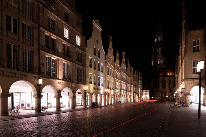Night street in Muenster, Germany with historic buildings and light trails