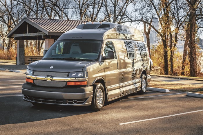 Roadtrek Chevrolet Van parked at a park