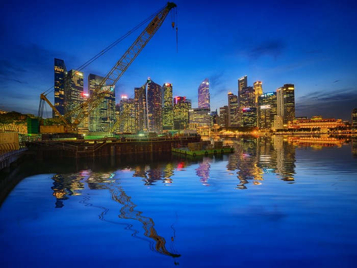 Singapore skyline with crane at dusk