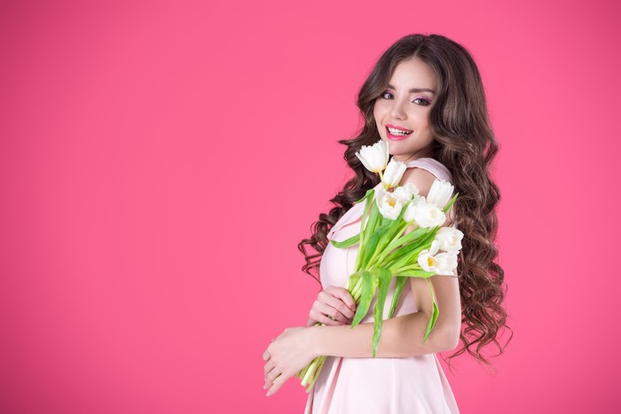 Woman with Tulips on Pink Background