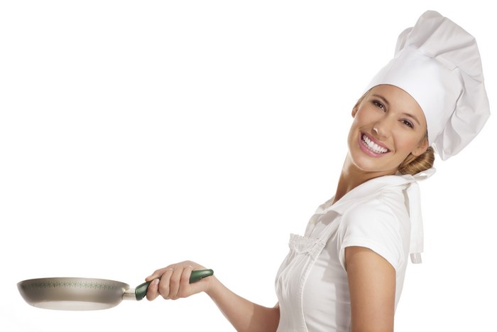 Woman in chef's hat holding frying pan