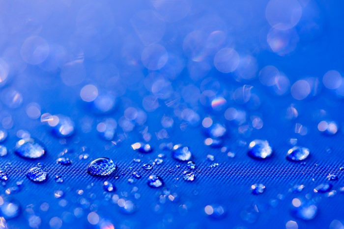 4K Closeup of Water Drops on Blue Surface