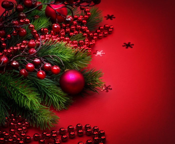 Christmas pine branches with red berries and ornaments