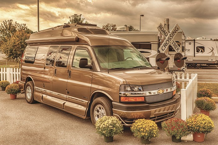 Brown Chevrolet Conversion Van with RVs and Railroad Crossing