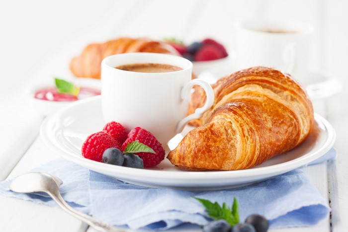 Croissant with coffee and berries