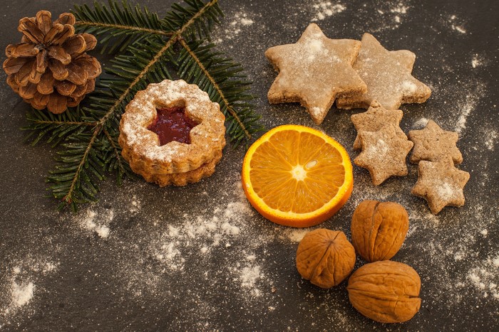 Christmas cookies with pine cone, orange slice, and walnuts
