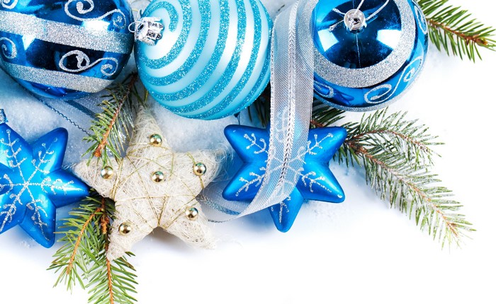 Christmas ornaments and pine branches on white background