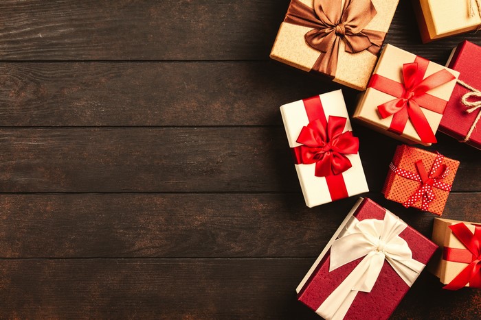 Christmas gifts with bows on wooden planks