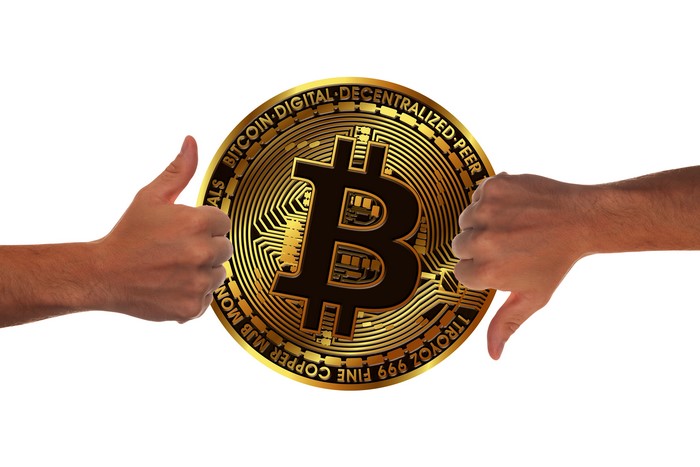 Bitcoin with Thumbs Up and Thumbs Down Hands