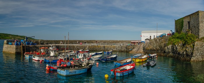 Boats docked in a harbor in Coverack, England