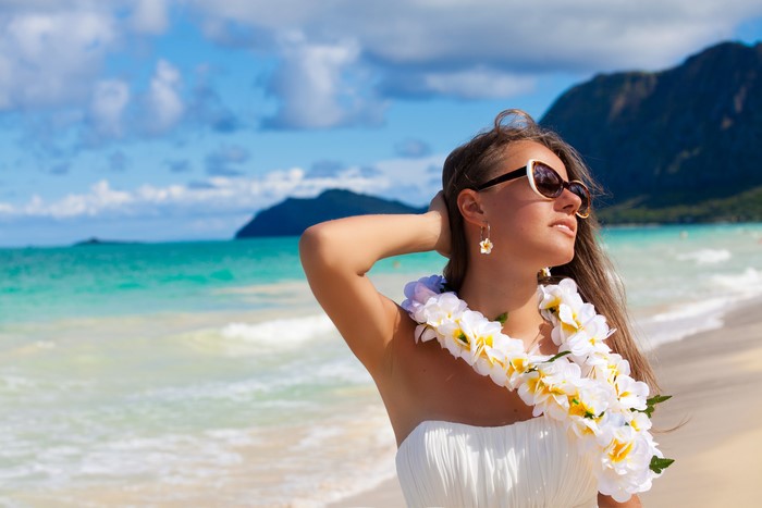 Woman with Lei and Sunglasses on Beach