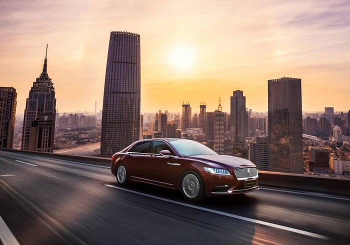 Lincoln Continental 3.0T AWD driving in city at sunset
