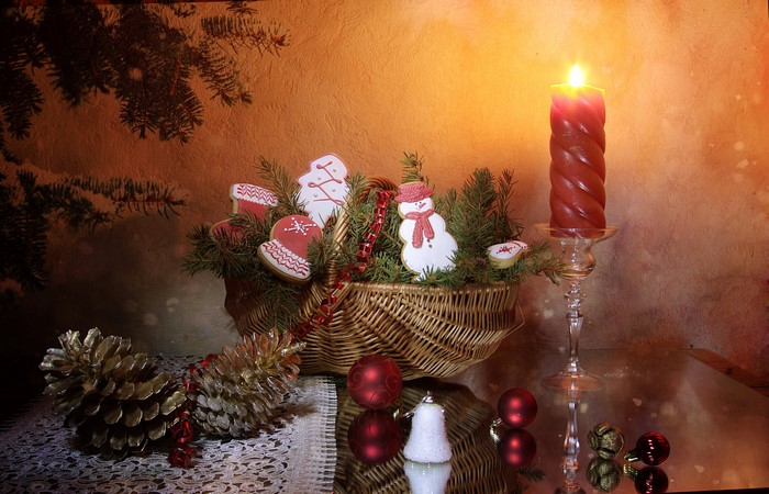 Christmas cookies in a basket with a candle