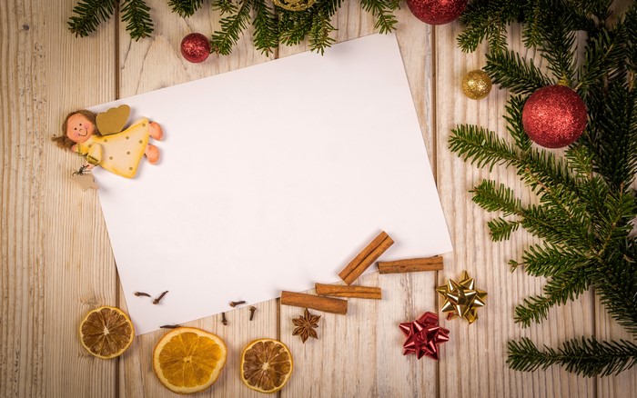 Christmas still life with angel, paper, and spices