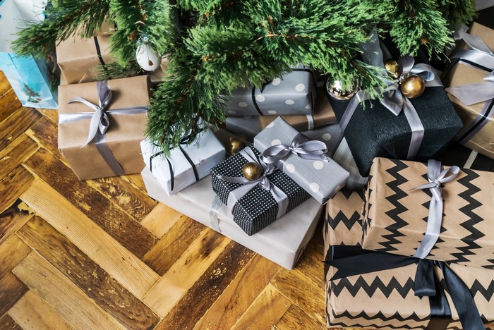 Christmas tree with gifts on wooden floor