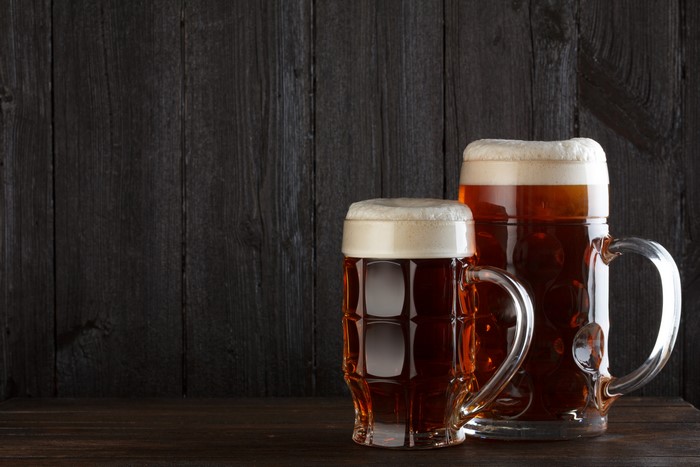 Two Mugs of Beer on Wood