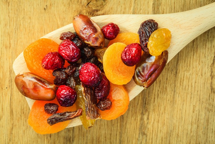 Dried fruits on a wooden spoon