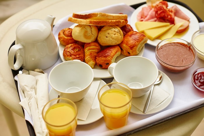 Breakfast tray with pastries, juice, and tea set