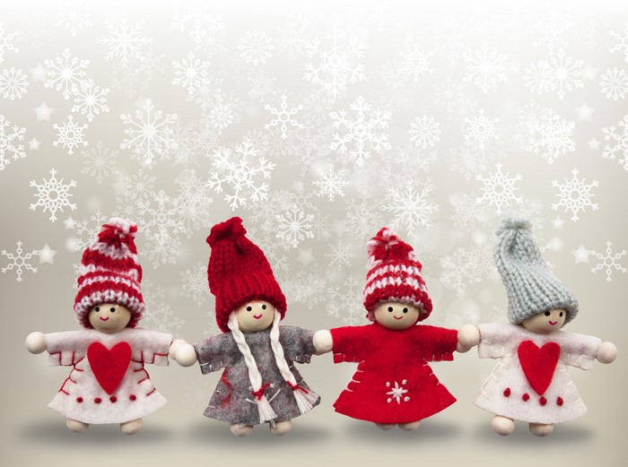 Four Christmas dolls with winter hats and snowflakes