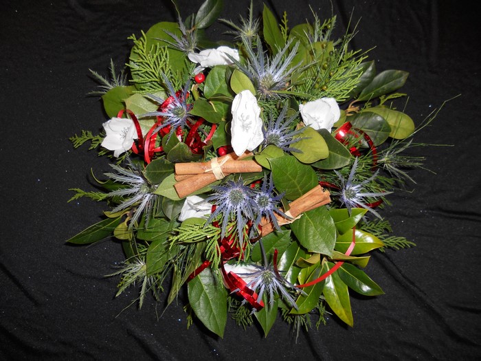 Christmas bouquet with anemones, foliage, and cinnamon sticks