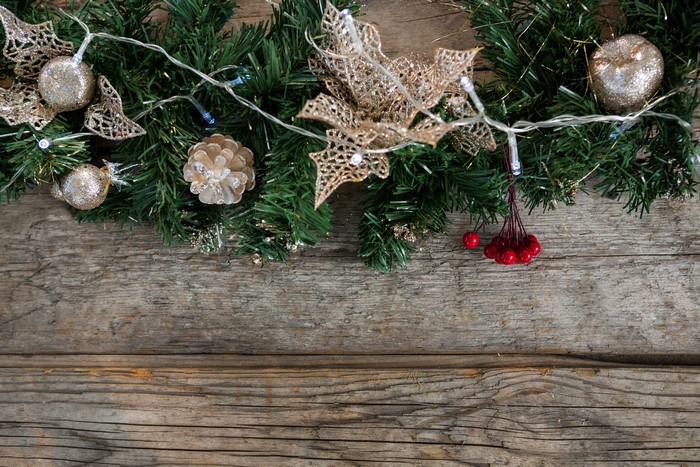 Christmas garland with ornaments on wood
