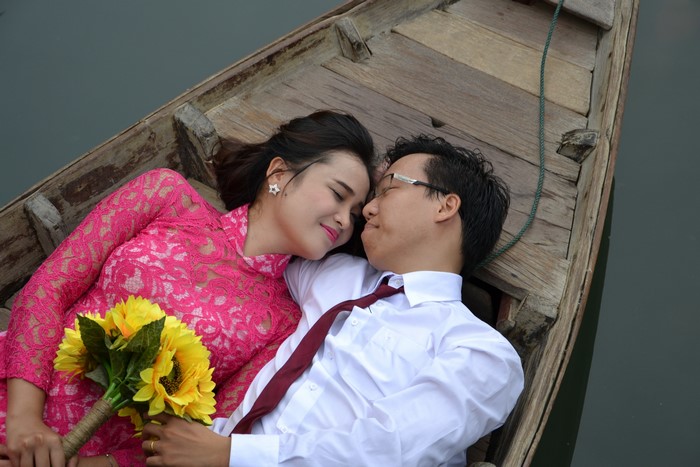 Couple in a boat with flowers