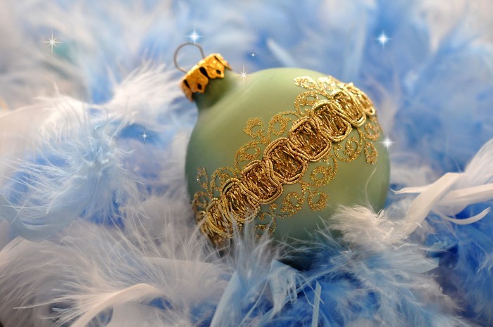 Christmas ornament with gold trim on blue and white feathers