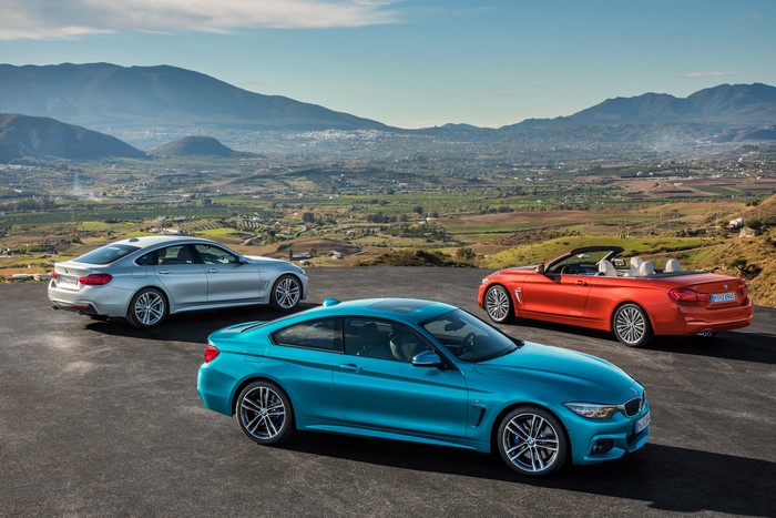 Three BMW 4 Series cars on a hill