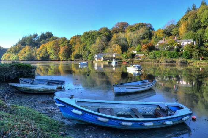 Boats on a river in Lerryn, England during autumn