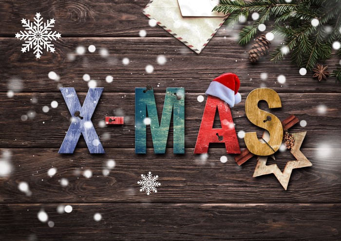 X-MAS letters with Christmas decorations on wood