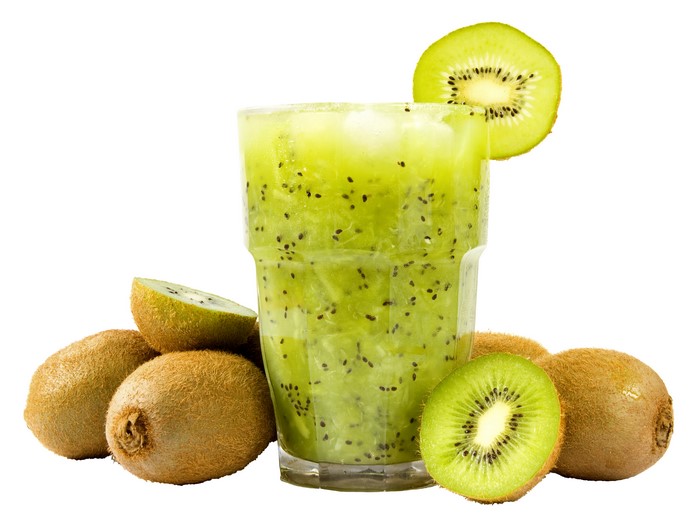 Kiwi juice in a highball glass with kiwis