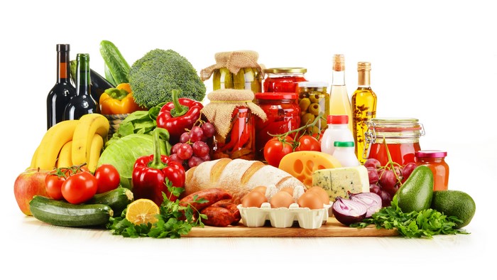 Still life of vegetables, fruit, bread, cheese, and bottles