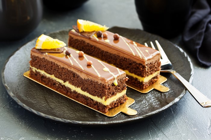 Two chocolate cakes with orange slices