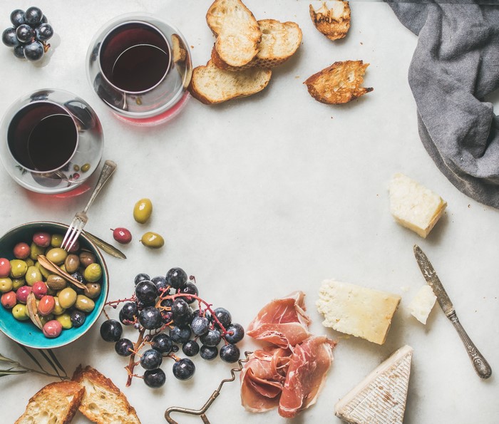 Grapes, Bread, Ham, Cheese, and Olives with Wine