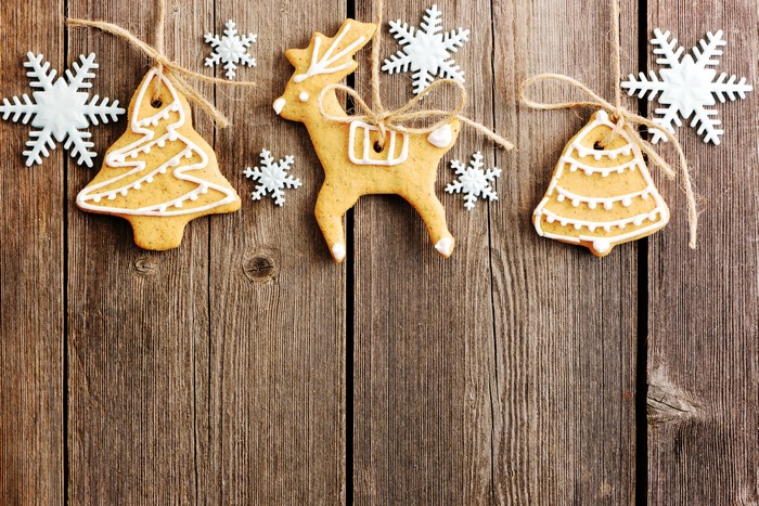 Christmas gingerbread cookies and snowflakes on wood