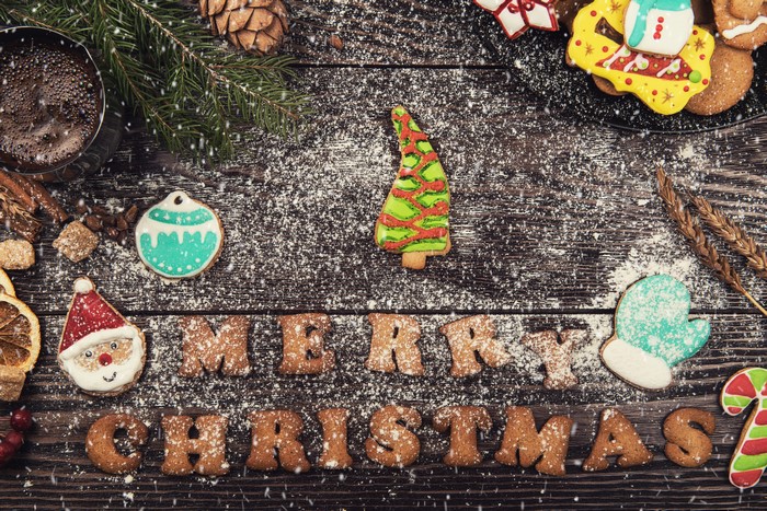 Christmas cookies with powdered sugar on wood